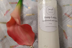 A gift of the Luxury Bath and Body Box by Lavish next to a flower.