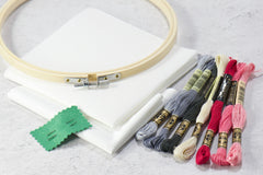 Cross stitch kit materials include instructions & tips guide, color black/white patterns, embroidery thread, fabric, needle