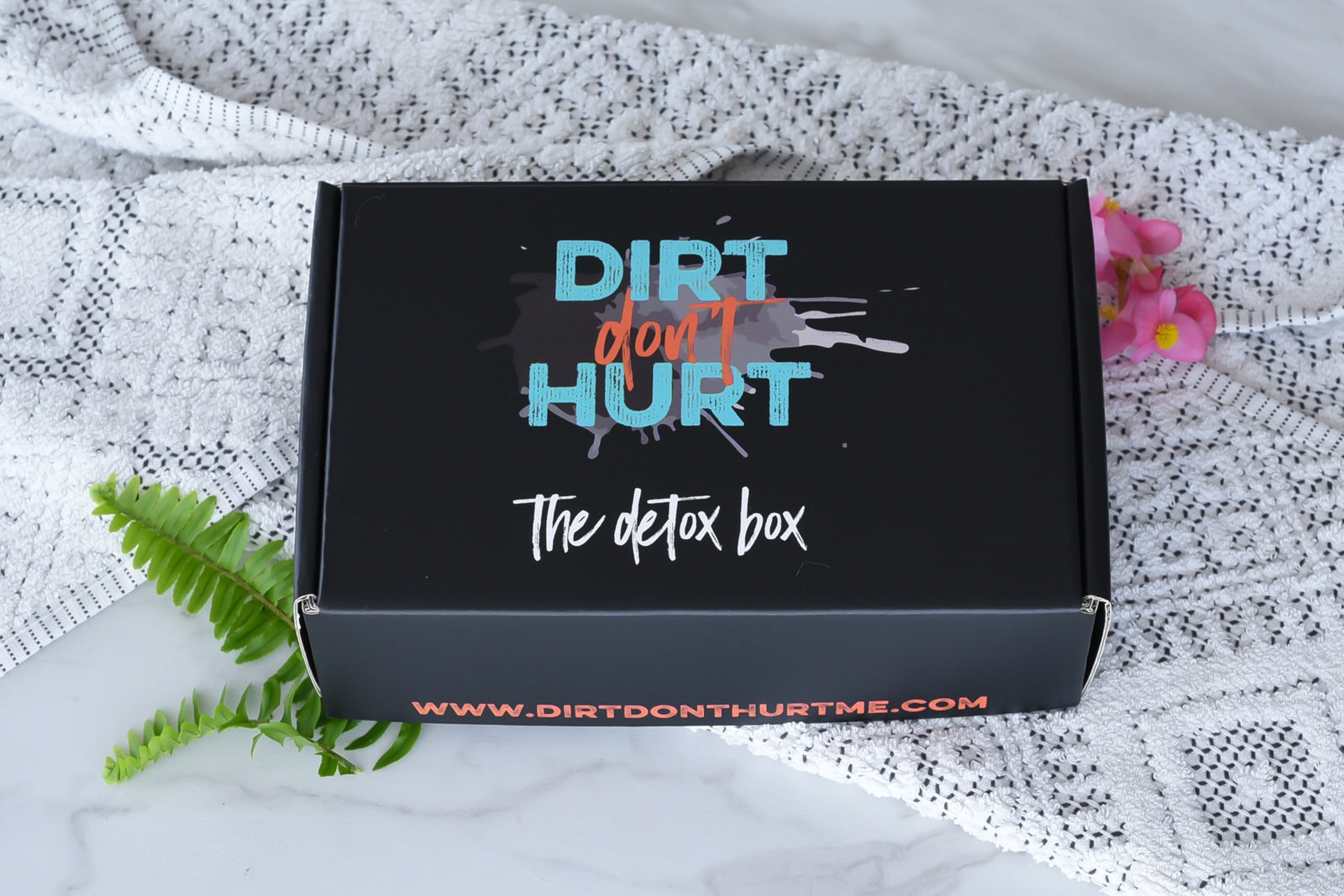 A closed The Detox Box subscription box that says dirt don't hurt.