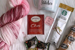 A sample of the Hand Dyed Yarn, stitch marker and extra items that will be offered in each quarterly box.