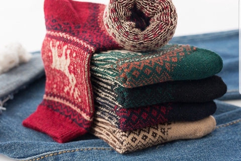 A pair of cozy, knitted socks, woven with a touch of yuletide charm, wraps our feet in warmth, invoking the feeling of sipping hot cocoa .
