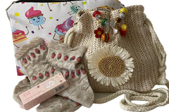 September '23 Girls Box of Unique Treasures: purse, strawberry themed socks, clear lip balm, accessories bag, LR Exclusive Bracelet.
