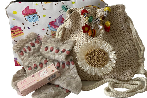 September '23 Girls Box of Unique Treasures: purse, strawberry themed socks, clear lip balm, accessories bag, LR Exclusive Bracelet.
