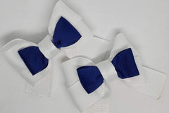 A navy tuxedo bow over a white double bow to make one unique hair bow. Both are grosgrain material. Elegant.