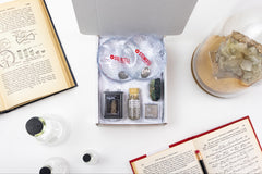 An open box displaying a selection of items that have been featured in past Matter boxes, featuring a chemical hand warmers