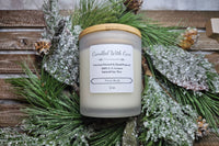Fan favorite French Vanilla featured in photo. Beautiful photo with an evergreen backdrop. Frosted jar with wooden lid.