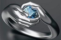 Solid silver ring shaped into what looks like, two hands grasping a 2 ctw blue sapphire stone, can be sized to fit, VERY UNIQUE