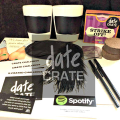 Items from a Date Crate subscription box including games and challenges for date night and pens and papers.