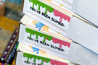 Slime Kit box exteriors stacked on top of each other. Rectangle flip top boxes for safe arrival of slime!