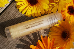 1 Natural, homemade lip balm, Watermelon,  Surrounded by calendula flowers. Picture taken in my back yard.