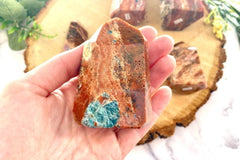 Photo of a blue apatite in orange calcite point as an example of a crystal of the month offered by Soul Gifts Crystals.