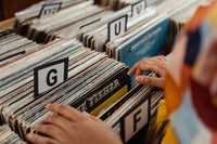 A cozy and inviting vinyl record store filled with shelves of vintage and contemporary albums