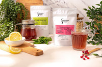 A gift bag of Everyday People Coffee & Tea's Great Tasting Sustainably Grown and Ethically Sourced Loose Leaf Tea Subscription displayed on a table.