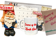 Gnome of the Month Club subscription box displayed on a front porch surrounded by neatly trimmed bushes