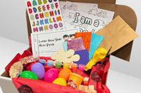 Open Activity Trunk box, showcasing molding clay, a paint pallet, a paintbrush, a balloon, plastic eggs, and an activity sheet."