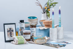 Items from an Artza subscription box, including candles, soap bars, olive oil, and other goods from across the Holy Land.