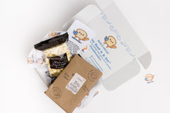 Read It & Eat Blind Date with a book.  Each box contains a food story, an artisanal snack, and a $5 donation to fight hunger in Buffalo, NY