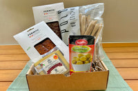 The IbericoTapas box including an exquisite selection of Iberico cured meats, manchego cheese, manzanilla olives and breadsticks.
