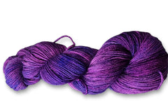 A beautiful Skein of Ultra Soft Hand Dyed Baby Alpaca Sport Weight Yarn in a deep rich purple color.
