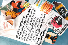 Items from a BlackLIT subscription box including soap, pancake and waffle mix, a book and bookmark and a shirt.