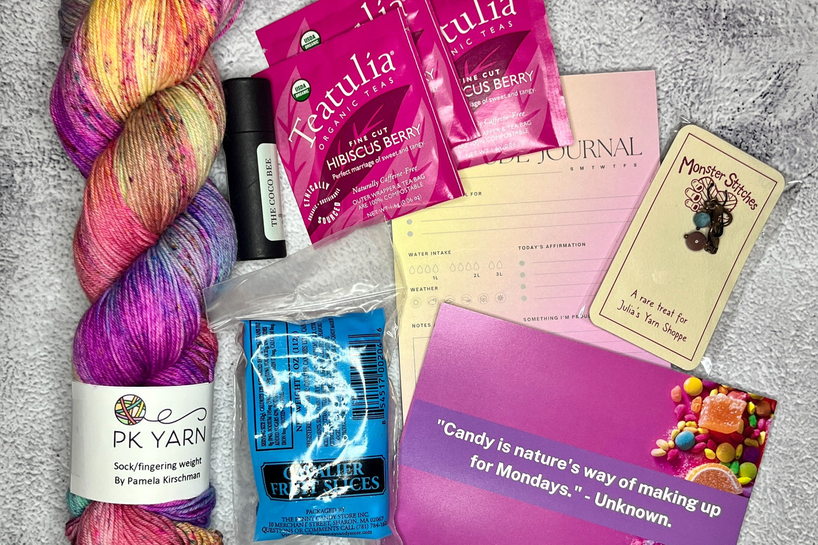 June 2023 box--You can always expect a high quality hand dyed yarn, tea samplert, and 3-4 goodies in a monthly box.