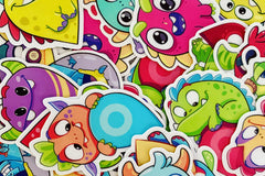 Picture shows fun assorted monster stickers that could be included in a Quirky Pickle pack. Stickers are selected based on age range.