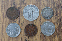Examples of collectible American coins included in gift boxes, including a buffalo nickel, Indian head penny, and standing Liberty quarter.