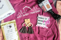 The Stable Box Subscription contents: a horse hoodie, horse treats, hay net, vinyl sticker and earrings.