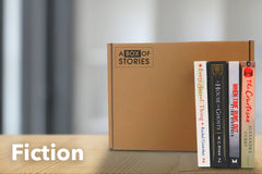 Brown subscription box filled with four surprise fiction books, offering captivating stories and diverse plots for literature lovers.