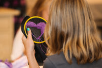 young girl learner beginning stitcher stitching a hoop for counted cross stitch diy hand embroidery project
