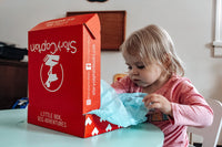 Girl unboxing WobbleCaptain box. With StoryCaptain, you will raise a little reader – one who is excited for adventure.