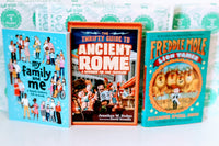 Three colorful children's books from the Kids Read Daily Book Club: "My Family and Me," "The Thrifty Guide to Ancient Rome," and "Freddie Mole, Lion Tamer"
