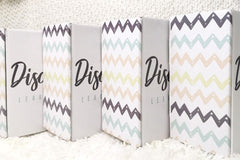 photo of the outside of the baby discovery boxes to show branded pattern.  boxes are lined up in a row. 