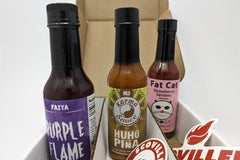 SCOVILLED hot sauce of the month subscription box featuring FAIYA Co., Karma Sauce, Fat Cat hot sauces. 