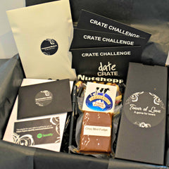 A Date Crate subscription box filled with games and challenges for date night, chocolate mint fudge, pens and notebooks.