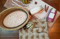 The 2022 Fall Box: a toasty bready basket, oversized scarf, potholder and trivet set, milky way bath soak and mulling spice blend.