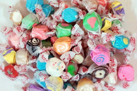 Assortment of saltwater taffy including flavors like watermelon, cherry, cupcake, orange cream, lemonade, and more.