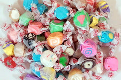 Assortment of saltwater taffy including flavors like watermelon, cherry, cupcake, orange cream, lemonade, and more.