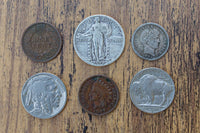 Examples of collectible American coins included in gift boxes, including a buffalo nickel, Indian head penny, and standing Liberty quarter.