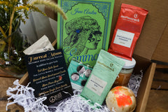 A red mug filled with three packets of Moonstruck milk chocolate, featured in the Peace & Pages monthly subscription box