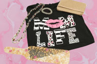 A black t-shirt from Oliver Christopher's Boutique with the words "mom life" on it, perfect as a gift.