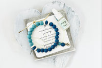 Blue Lava Diffuser Bracelet with Silver Moon Charm in White Gift Box with Aromatherapy Instruction Card and Happy Place Mini Oil Dropper.