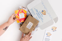 Read It & Eat Blind Date with a book.  Each box contains a food story, an artisanal snack, and a $5 donation to fight hunger in Buffalo, NY