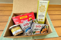 Seafood Tapas box, including Lobster Pate spread, Mussels in Pickled Sauce, Cockles in Brine, Vegan Crackers and Anchovies Stuffed Olives.