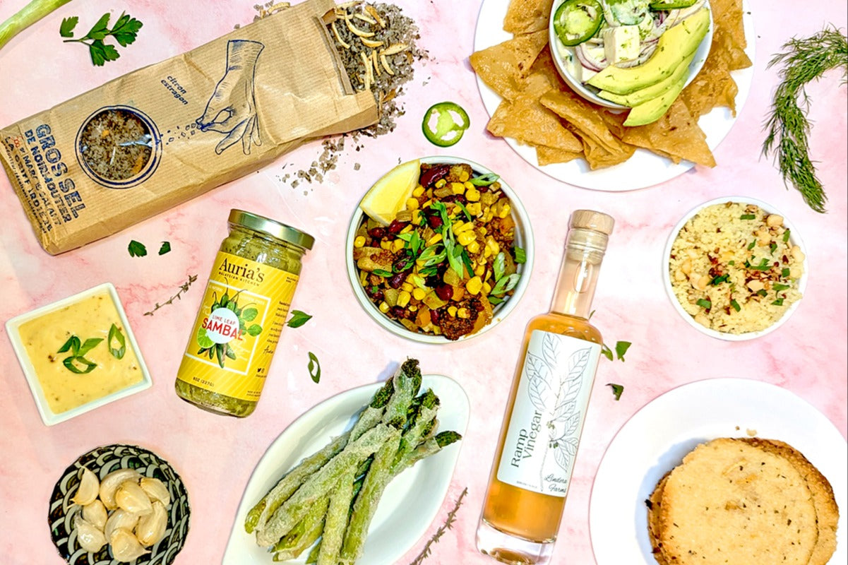 Culinarie LUXE ingredients arranged around dishes made from them, like Cajun-inspired succotash, coconut tofu ceviche, ramp aioli, and more.