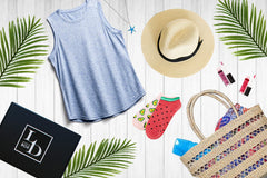 Items from a LD Accessories subscription box including a grey tank top, a sun hat, cute socks, lip gloss and a tote bag.