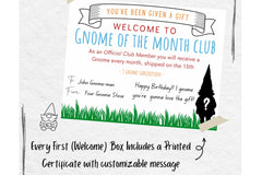 Gnome of the Month Club subscription box displayed on a front porch surrounded by neatly trimmed bushes