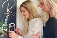 Entry Envy Decor Kits shown being inserted into one of our custom, handmade wooden last name monogram signs. 