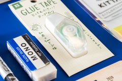 Close-up picture of notebook, pencils, stickers, pen, eraser, and business card. These items are an example of what may be included.