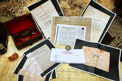 Vintage coin, personalised letter, and photocopied national archive documents rest on top of papyrus and woodwool, stone and box